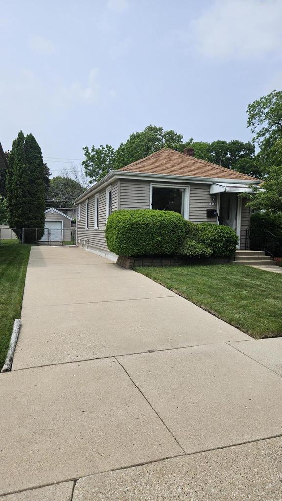 1518 Lathrop Ave, Racine, WI 53405 - view of front of home with a front lawn, an outbuilding, and concrete driveway