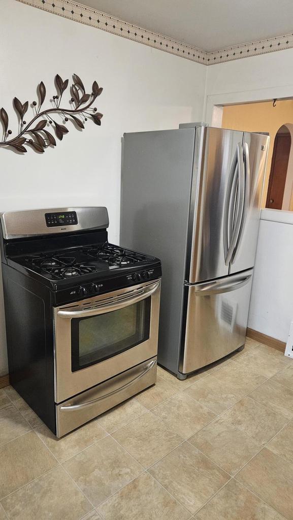 1518 Lathrop Ave, Racine, WI 53405 - kitchen with appliances with stainless steel finishes and baseboards