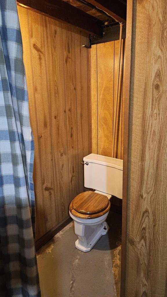 1518 Lathrop Ave, Racine, WI 53405 - bathroom with concrete flooring and wood walls