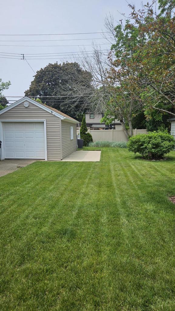 1518 Lathrop Ave, Racine, WI 53405 - view of yard featuring a garage and an outbuilding