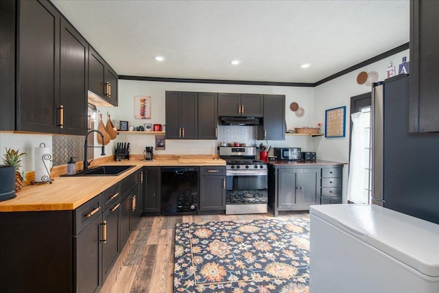 158 S State St, Berlin, WI 54923 - kitchen with appliances with stainless steel finishes, under cabinet range hood, open shelves, light wood finished floors, and wood counters