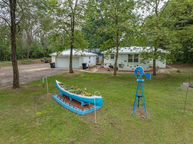 1207 S Main St, Necedah, WI 54646 - view of green lawn featuring a garage, dirt driveway, and an outbuilding