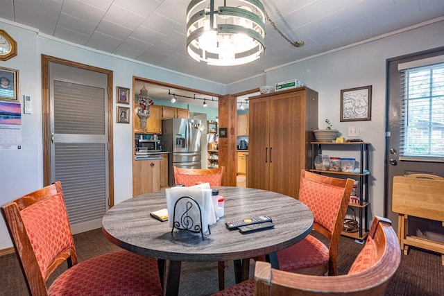 1207 S Main St, Necedah, WI 54646 - dining room featuring rail lighting, crown molding, and carpet floors