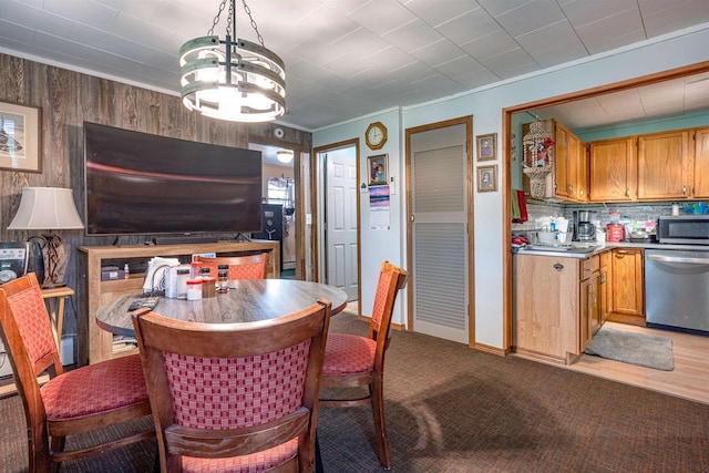 1207 S Main St, Necedah, WI 54646 - dining room with a chandelier, light carpet, wooden walls, and crown molding