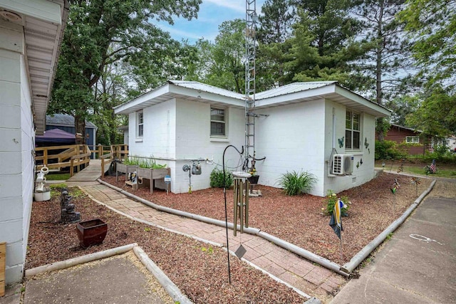 1207 S Main St, Necedah, WI 54646 - view of front of home featuring concrete block siding and a metal roof