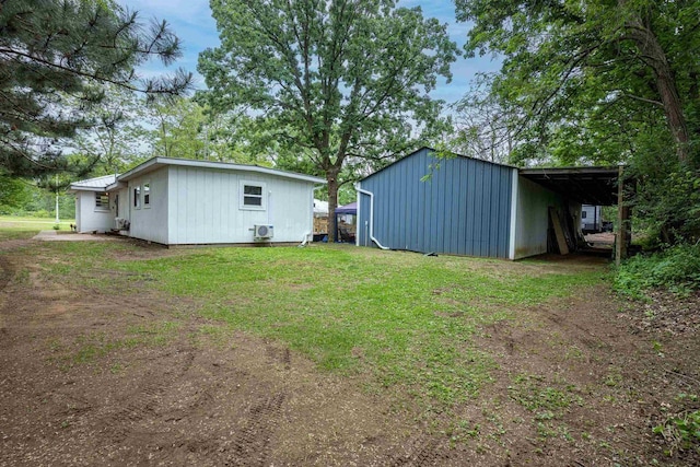 1207 S Main St, Necedah, WI 54646 - view of green lawn with a carport, an outdoor structure, and an outbuilding