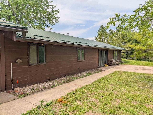 774 Enloe Rd, Rewey, WI 53580 - view of side of home with a metal roof, a lawn, and a patio area