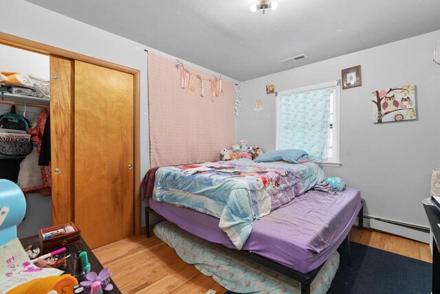 1-3 Mechanic St, Edgerton, WI 53534 - bedroom featuring baseboard heating, wood finished floors, and a closet