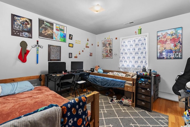 1-3 Mechanic St, Edgerton, WI 53534 - bedroom with wood finished floors and a baseboard heating unit