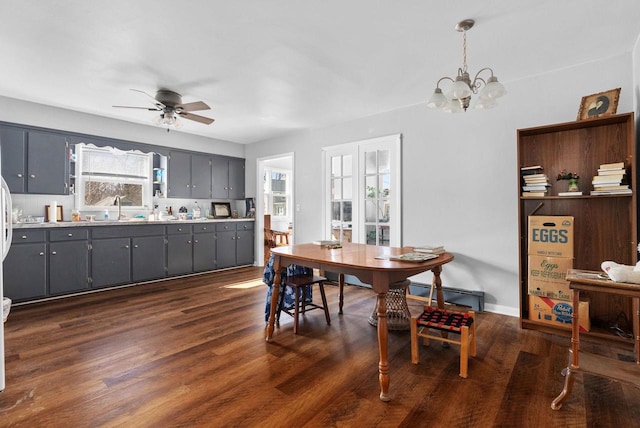 1-3 Mechanic St, Edgerton, WI 53534 - dining area with a baseboard radiator, a chandelier, a ceiling fan, and dark wood finished floors