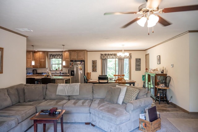W5671 8th St, Necedah, WI 54646 - living area featuring a chandelier, ornamental molding, a ceiling fan, and dark colored carpet