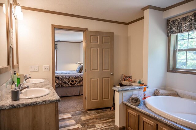 W5671 8th St, Necedah, WI 54646 - full bathroom with double vanity, wood finished floors, a garden tub, crown molding, and connected bathroom