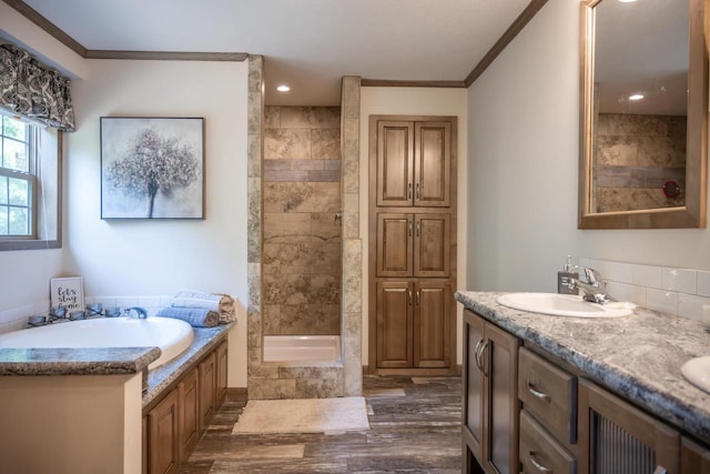 W5671 8th St, Necedah, WI 54646 - full bath featuring a garden tub, ornamental molding, wood finished floors, double vanity, and a tile shower