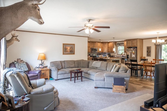 W5671 8th St, Necedah, WI 54646 - living area featuring carpet flooring, ornamental molding, a chandelier, and a ceiling fan