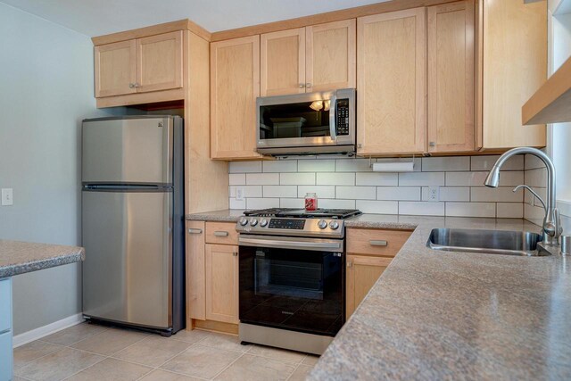 6592 Whalen Rd, Verona, WI 53593 - kitchen with stainless steel appliances, light brown cabinets, decorative backsplash, and light countertops