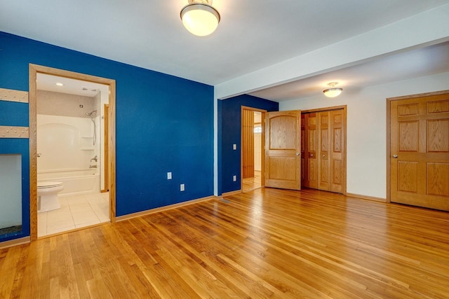 6592 Whalen Rd, Verona, WI 53593 - unfurnished bedroom with light wood finished floors, a closet, and ensuite bathroom