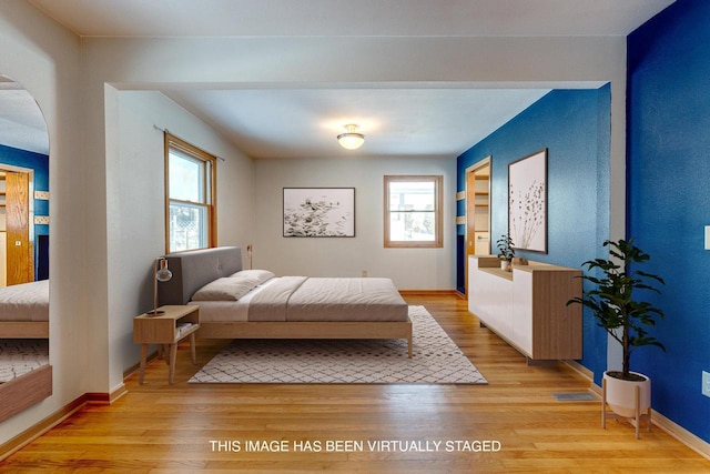 6592 Whalen Rd, Verona, WI 53593 - bedroom featuring arched walkways and light wood finished floors