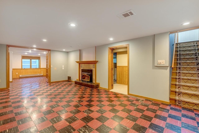 6592 Whalen Rd, Verona, WI 53593 - unfurnished living room with baseboard heating, a fireplace, recessed lighting, and wood walls