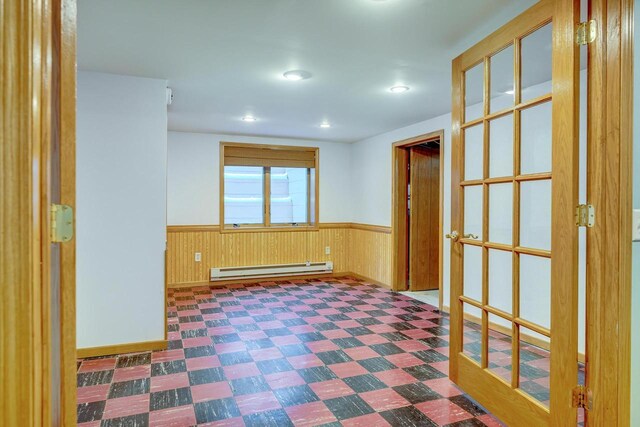 6592 Whalen Rd, Verona, WI 53593 - spare room featuring baseboard heating, a wainscoted wall, tile patterned floors, wood walls, and recessed lighting