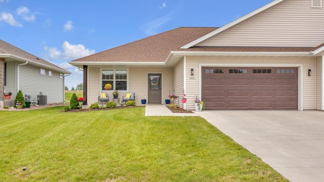 2824 Granite Ct, Sheboygan, WI 53081 - view of front of property with a front lawn, concrete driveway, an attached garage, and a porch