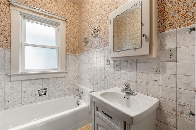 225 W Elm St, Chippewa Falls, WI 54729 - full bathroom with tile walls, a tub to relax in, wallpapered walls, and wainscoting