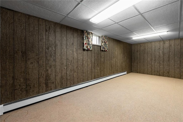 225 W Elm St, Chippewa Falls, WI 54729 - basement featuring a baseboard heating unit, carpet flooring, a drop ceiling, and wood walls