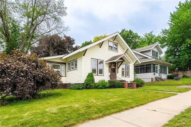 225 W Elm St, Chippewa Falls, WI 54729 - view of front facade featuring a sunroom, a front yard, and crawl space