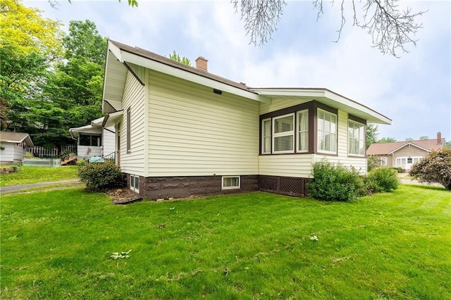225 W Elm St, Chippewa Falls, WI 54729 - view of side of property featuring a chimney and a lawn