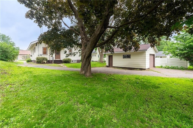 225 W Elm St, Chippewa Falls, WI 54729 - view of green lawn featuring an outdoor structure and a garage