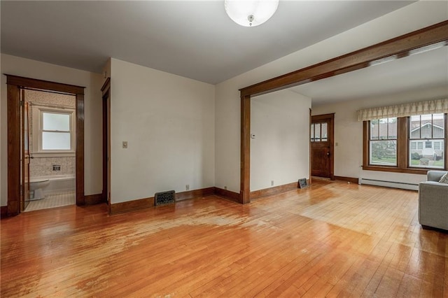 225 W Elm St, Chippewa Falls, WI 54729 - unfurnished living room with light wood-style floors and baseboard heating