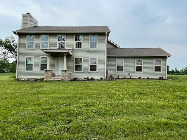 23826 18th St, Union Grove, WI 53182 - back of property featuring a chimney and a lawn