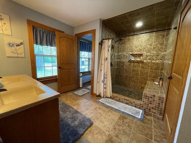 23826 18th St, Union Grove, WI 53182 - bathroom with a tile shower, vanity, tile patterned floors, and recessed lighting