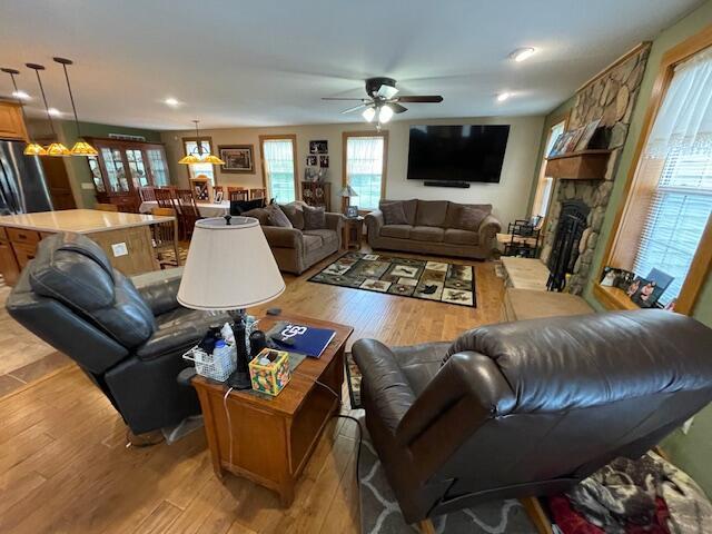 23826 18th St, Union Grove, WI 53182 - living area featuring light wood-style floors, ceiling fan, a stone fireplace, and recessed lighting