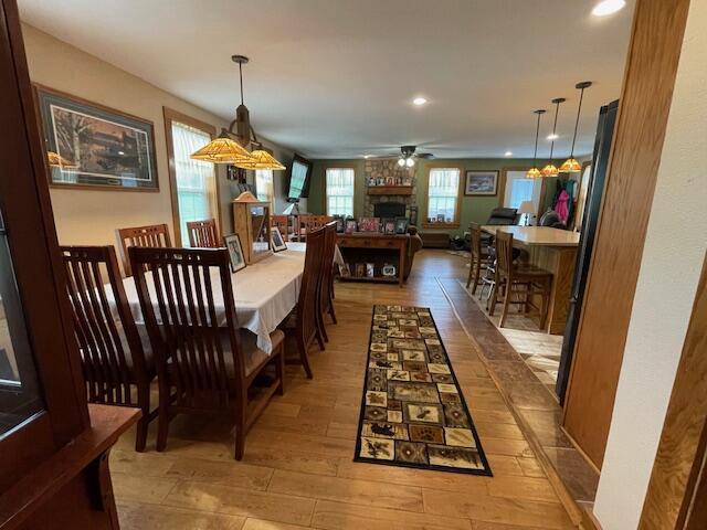 23826 18th St, Union Grove, WI 53182 - dining room featuring hardwood / wood-style flooring, ceiling fan, a large fireplace, and recessed lighting