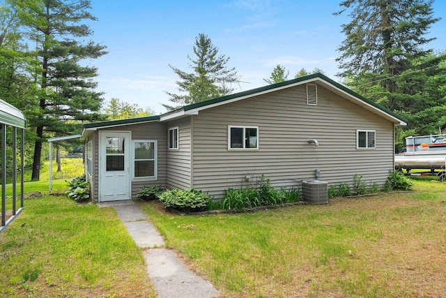 W9173 W 10th Rd, Pound, WI 54161 - view of home's exterior featuring a lawn and a cooling unit