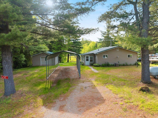 W9173 W 10th Rd, Pound, WI 54161 - view of green lawn featuring driveway and a detached carport