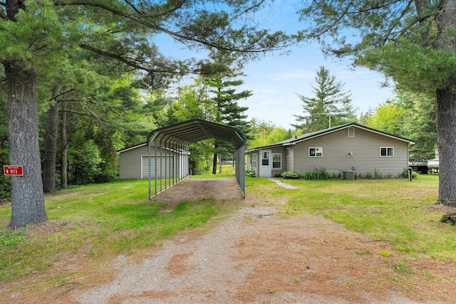 W9173 W 10th Rd, Pound, WI 54161 - view of green lawn featuring a detached carport, dirt driveway, and an outdoor structure
