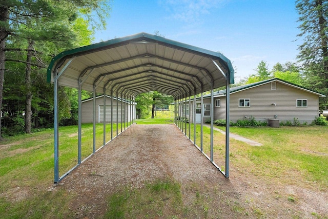 W9173 W 10th Rd, Pound, WI 54161 - view of vehicle parking featuring a carport, driveway, and a storage unit