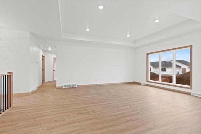 399 Battery Ave, De Pere, WI 54115 - unfurnished room featuring a tray ceiling, light wood-type flooring, and recessed lighting