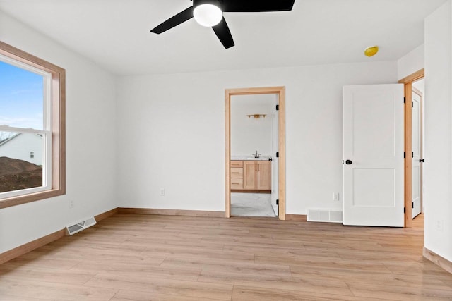 399 Battery Ave, De Pere, WI 54115 - unfurnished bedroom featuring light wood finished floors, ensuite bath, and ceiling fan