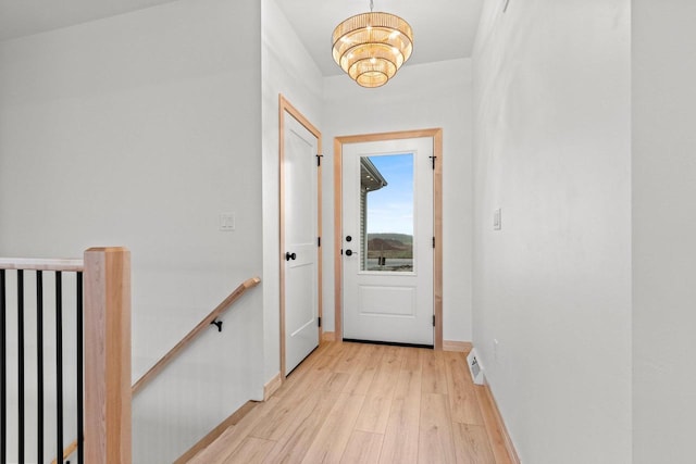 399 Battery Ave, De Pere, WI 54115 - doorway to outside featuring light wood-type flooring and a chandelier