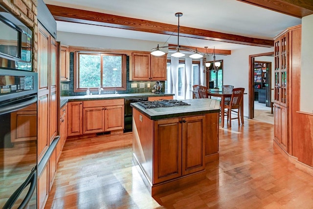 3590 Sabaka Trl, Verona, WI 53593 - kitchen featuring black appliances, beam ceiling, a center island, light wood-style floors, and brown cabinetry