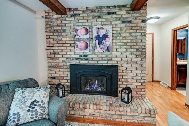 3590 Sabaka Trl, Verona, WI 53593 - detailed view of beam ceiling, wood finished floors, and a fireplace