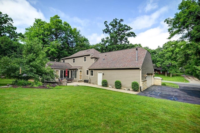 3590 Sabaka Trl, Verona, WI 53593 - back of property featuring a lawn, roof with shingles, and a patio