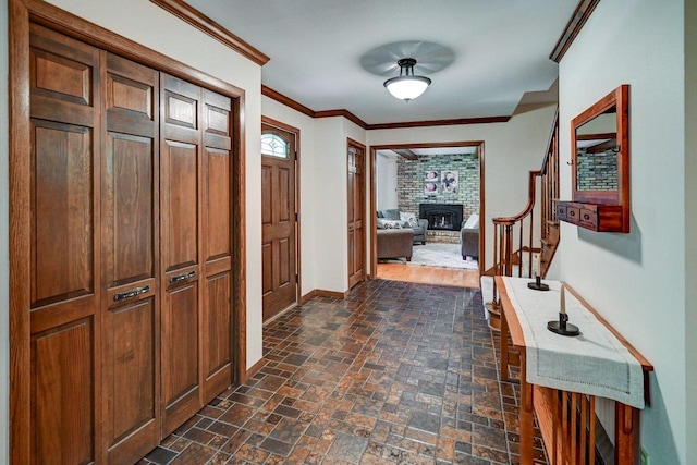 3590 Sabaka Trl, Verona, WI 53593 - entrance foyer featuring ornamental molding, stairway, a brick fireplace, and brick patterned floors