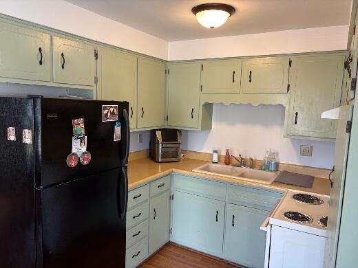 2408 Park Pl Unit D, Sheboygan, WI 53083 - kitchen with freestanding refrigerator, light countertops, white electric range oven, and wood finished floors