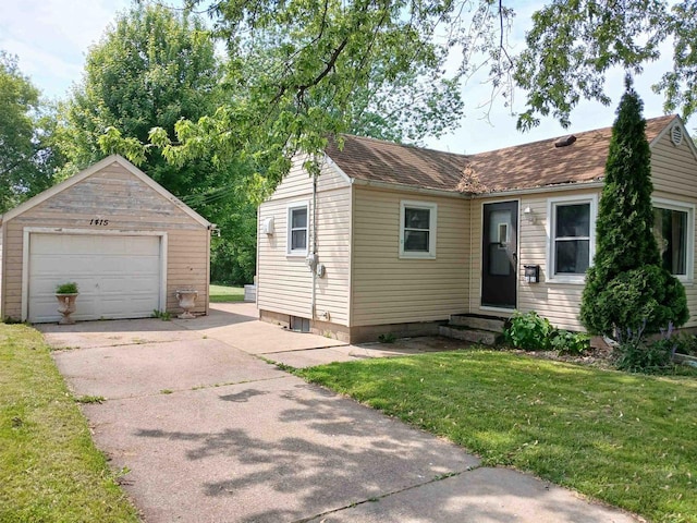 1415 S Kernan St, Appleton, WI 54915 - view of front of house featuring a garage, driveway, a front lawn, an outbuilding, and entry steps