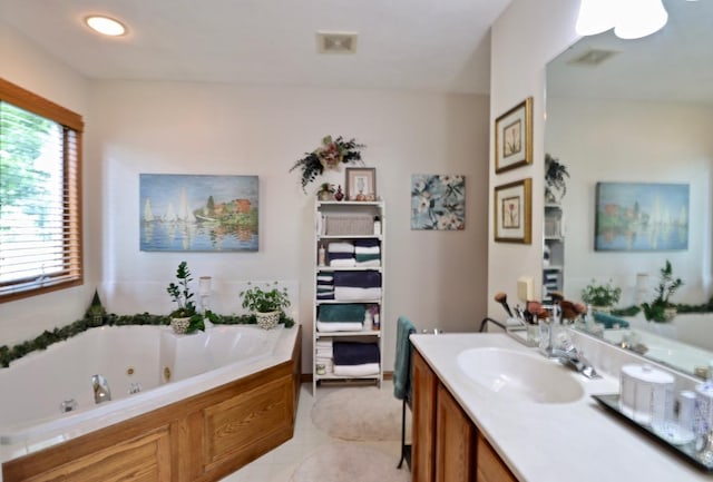 2360 Cobblestone Ln, Beloit, WI 53511 - bathroom with vanity, a tub with jets, and tile patterned flooring
