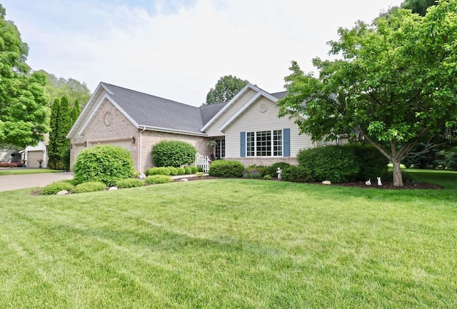 2360 Cobblestone Ln, Beloit, WI 53511 - view of front of property featuring a garage, brick siding, a front lawn, and driveway