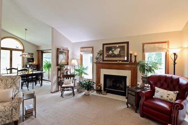 2360 Cobblestone Ln, Beloit, WI 53511 - living area featuring vaulted ceiling, carpet floors, and a fireplace with flush hearth